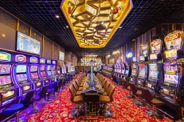 A close-up shot of golden coins falling around a spinning roulette wheel, representing immersive casino action at 5666BDTT.